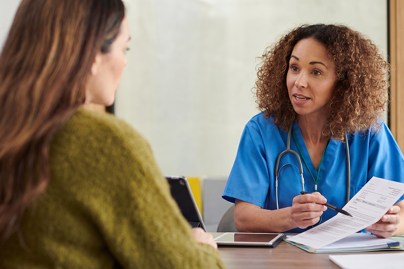 Young woman talking with a female doctor