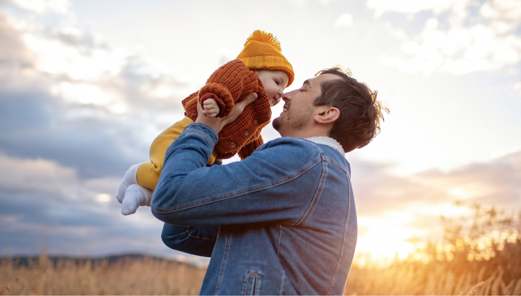 Man holding his baby in the air